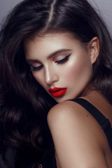 Fototapeta premium Closeup portrait of beautiful woman with bright elegant make-up. Sexy young woman with red lipstick and black long hair.
