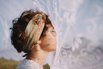 Portrait of womanwith lace shadows on her face