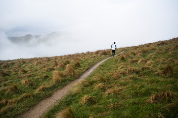 Man running along a dirt track.