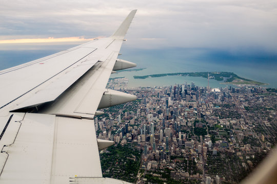 Toronto and the wing of an aircraft, at dusk