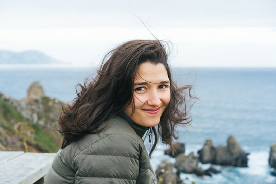 A Girl Sights The Ocean From a Cliff.