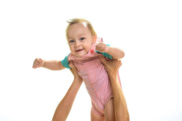 Lets fly away. Small child with adorable smile. Happy small baby being held in hands. Little boy child. Little baby boy. Happy childhood and babyhood. Early childhood development