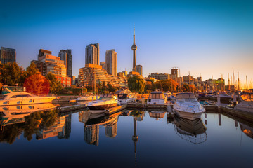 View of harbor in a yacht club at Toronto city during sunset with Canadian tower as background