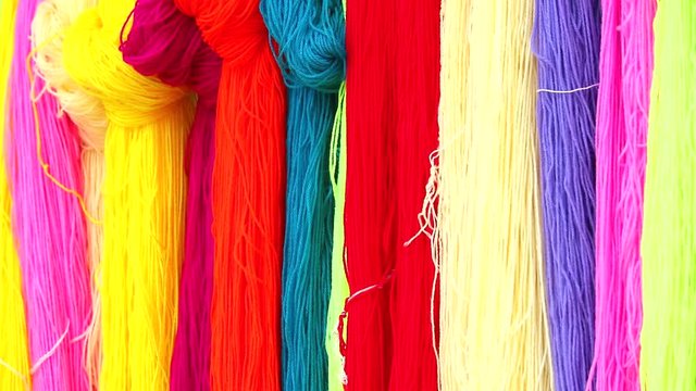 Multi-colore yarn hanging on the rails to do various things