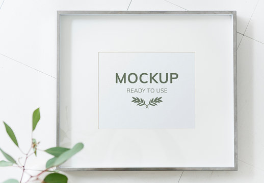 Mockup of Frame Hanging on a White Wall