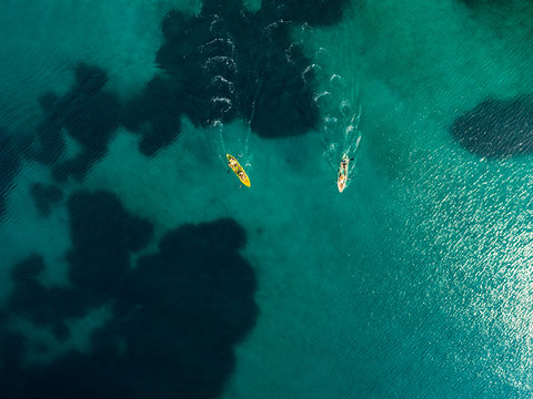 Exploring Greece seashore on a canoe