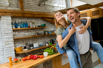 Lovely couple having fun together at rustic kitchen