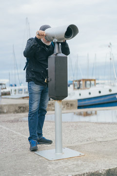 Man Looking Through A Binoculars.
