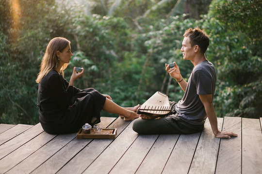 Couple in leisure on terrace with tea