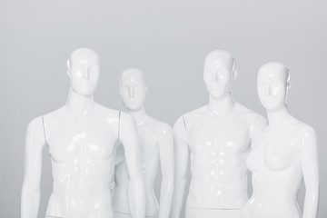 white plastic mannequin dummies isolated on grey