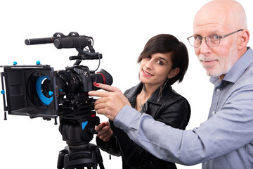 cameraman and a young woman with a movie camera DSLR on white