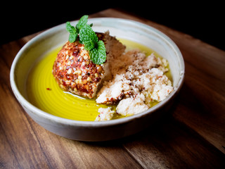 Shanklish cheese covered with zaatar and dried pepper in olive oil. Arabian cheese.