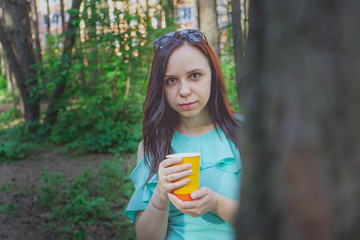 Woman with takeaway drink walk on street. Woman hold disposable coffee cup. Coffee or tea mood....