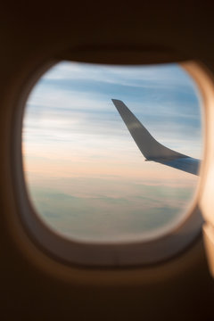 View to the sky and wing through the airplane window