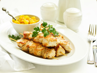 chicken skewers with apple-apricot chutney. Selective focus.