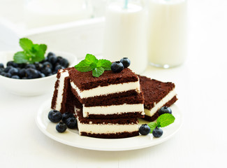 Delicate chocolate creamy cake with raspberries.