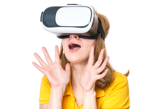 Surprised woman in virtual reality glasses. Portrait of young woman with VR headset. Happy girl using future technology, isolated on white background.