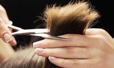 Man having a haircut with scissors
