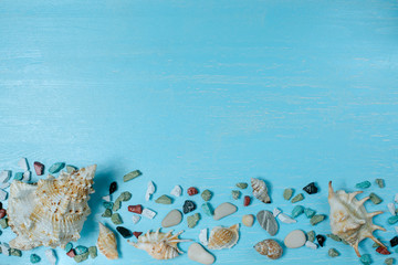 Beach blue wooden relax background with big and small shells and bright color sea stones flat lay  for summer holiday and vacation concept. Travel and tourism idea - Powered by Adobe