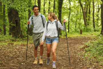 Young couple hiking in nature.They enjoying in walk and fresh air.