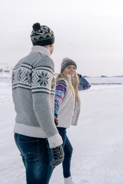 Romantic couple skating on rink