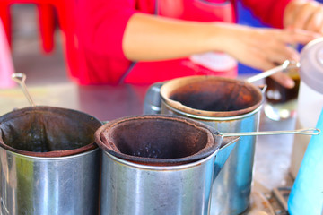Fototapeta na wymiar Woman's hands preparing traditional hot and iced coffee cup - traditional coffee drink - fresh coffee drink preparation
