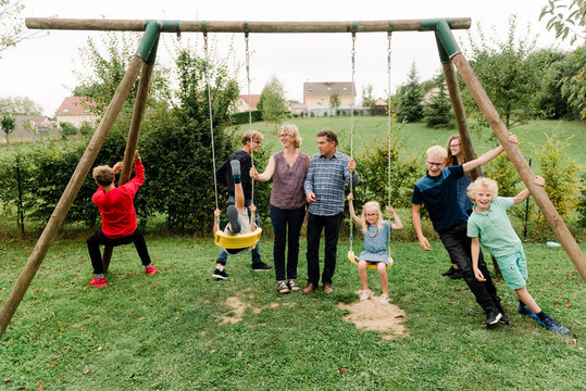 large family with 7 kids by swing set