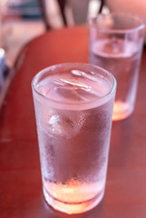 Glass water drink with tube blurred background