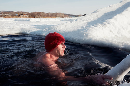 Ice swimmer coming out of water