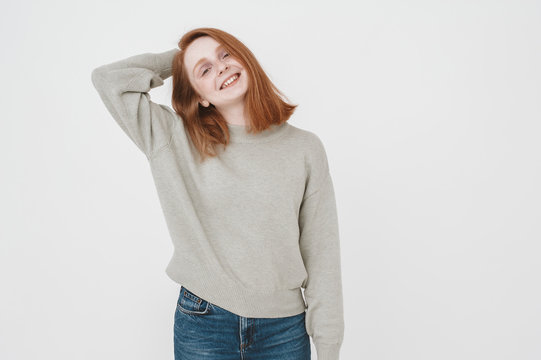 Young ginger woman looking at camera