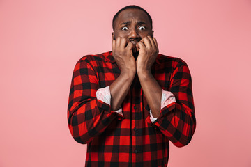 Portrait of a scared african man wearing plaid shirt