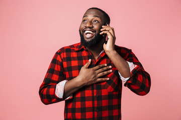 Portrait of a happy casual african man standing isolated