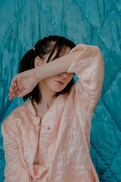 Portrait of anonymous female model in pastel pajama at home