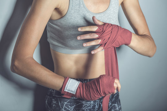 Woman Is Wrapping Hands With Red Boxing Hand Wraps