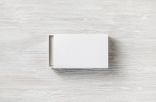 White Cardboard Sliding Open Box On Light Wooden Background. Flat Lay.