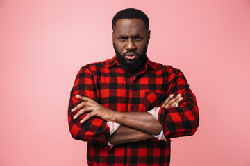 Portrait of an angry african man wearing plaid shirt