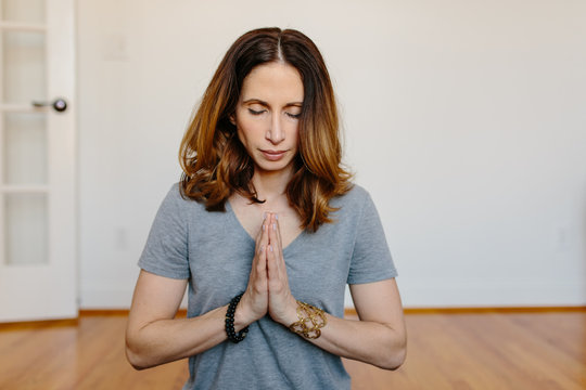 Beautiful woman practicing meditation at home