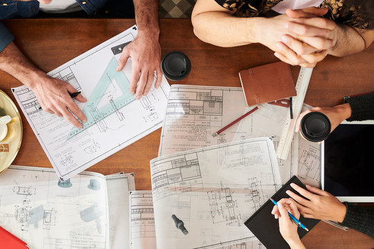 Architects working with drawings in office.