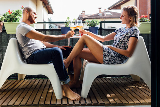 Adult Couple having a Drink in a Terrace together