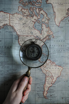 using a magnifying glass ver a map