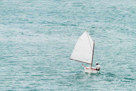 Boy in an optimist dinghy in English Harbour in Antigua