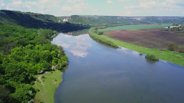 Flight over the river and forest at spring time. Dniester river of Moldova republic.