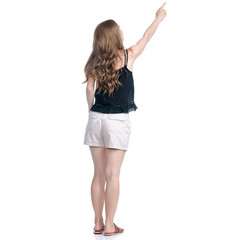 Woman in shorts standing looking showing pointing on white background isolation, back view