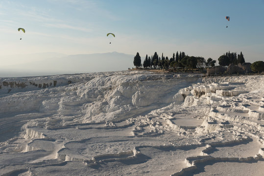 Skydivers flying over limestone landscape