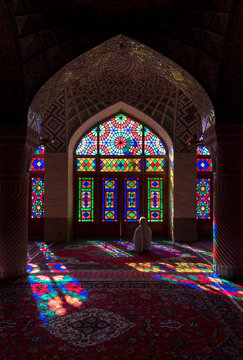 Anonymous woman inside of colorful oriental mosque