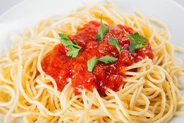 Macaroni with tomato sauce on white background