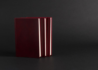 books with red cover on black background, isolated. back to school