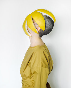 Bald woman with pomelo peel on face