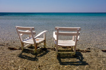 Two armchairs in the water, beach in Cesme, Izmir, Turkey