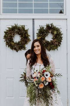 Bridesmaid Peeking out from behind Bride's Shoulder